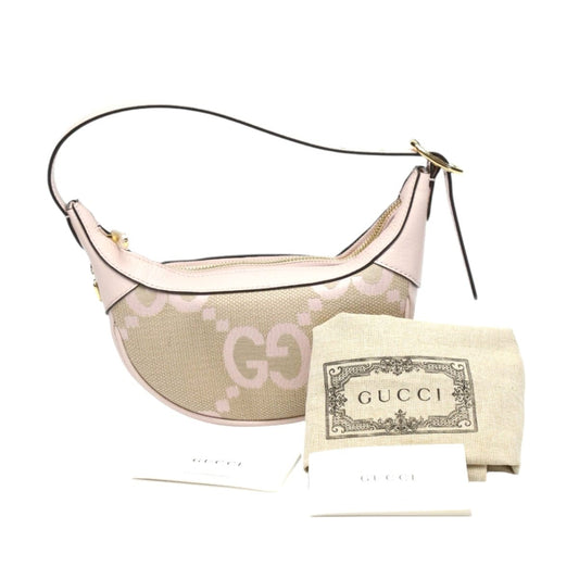 Beige Gucci handbag with matching pouch on a white background