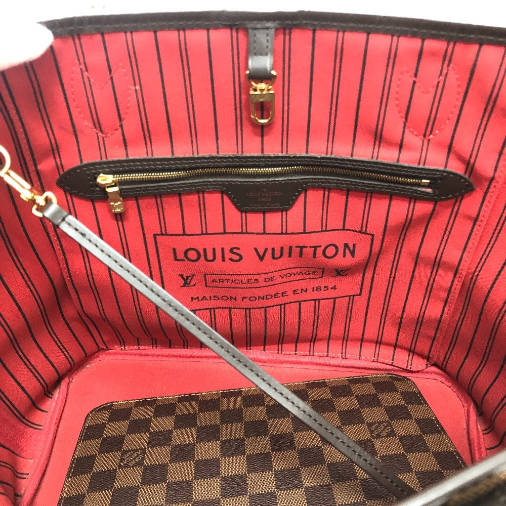 Louis Vuitton bag interior with red lining and checkered pattern