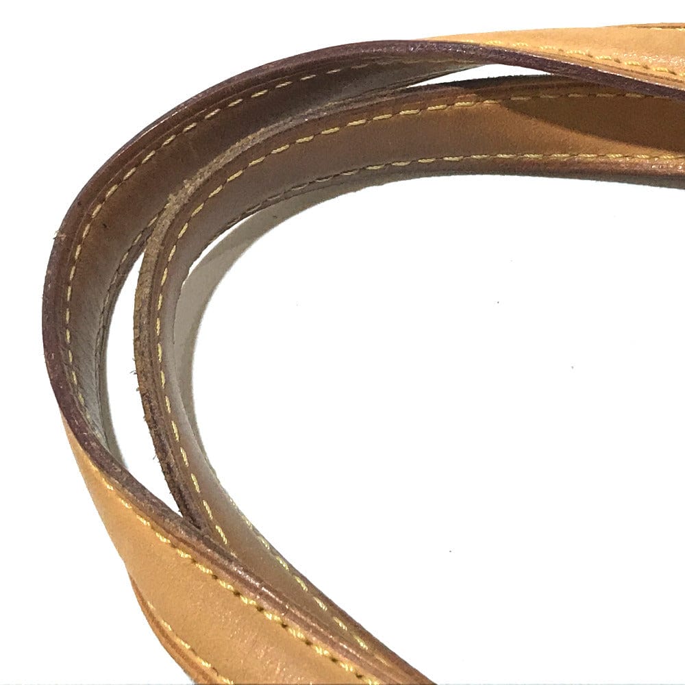 Close-up of a brown leather belt with visible stitching on a white background