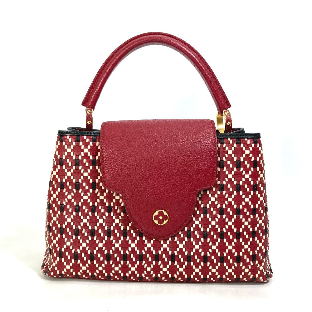 Handbag with red patterned body and red handle on a white background