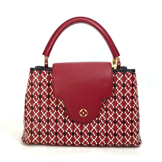 Handbag with red patterned body and red handle on a white background