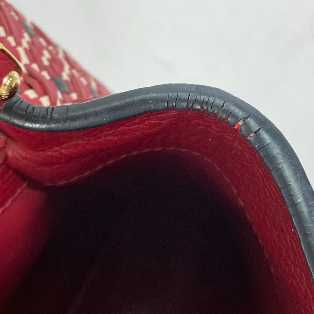Close-up of a red purse with a gold clasp on a white background