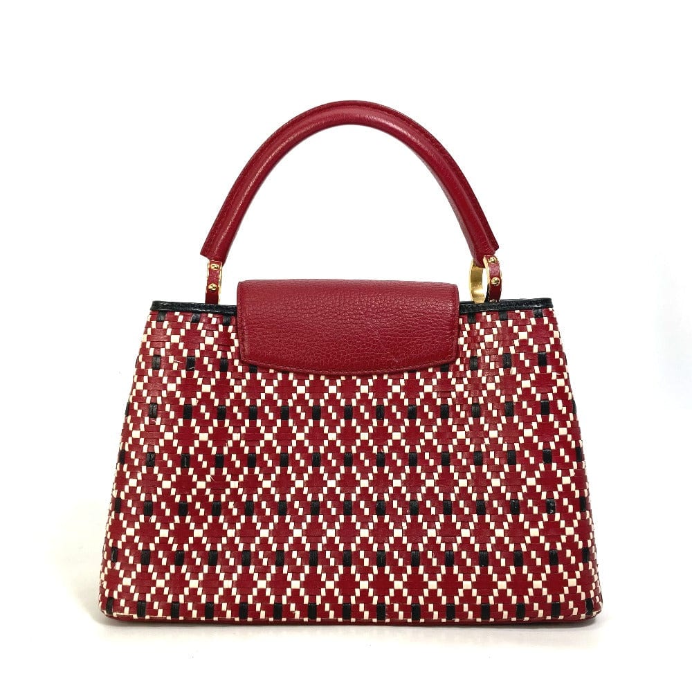 Red patterned handbag with a matching handle on a white background