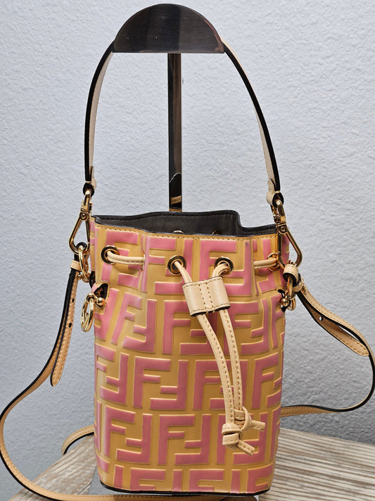 A pre-loved Fendi Vitello Liberty Mini Mon Tresor Bucket Bag in beige, pink, and yellow with gold hardware, featuring a FF monogram-embossed leather design and a removable shoulder strap.