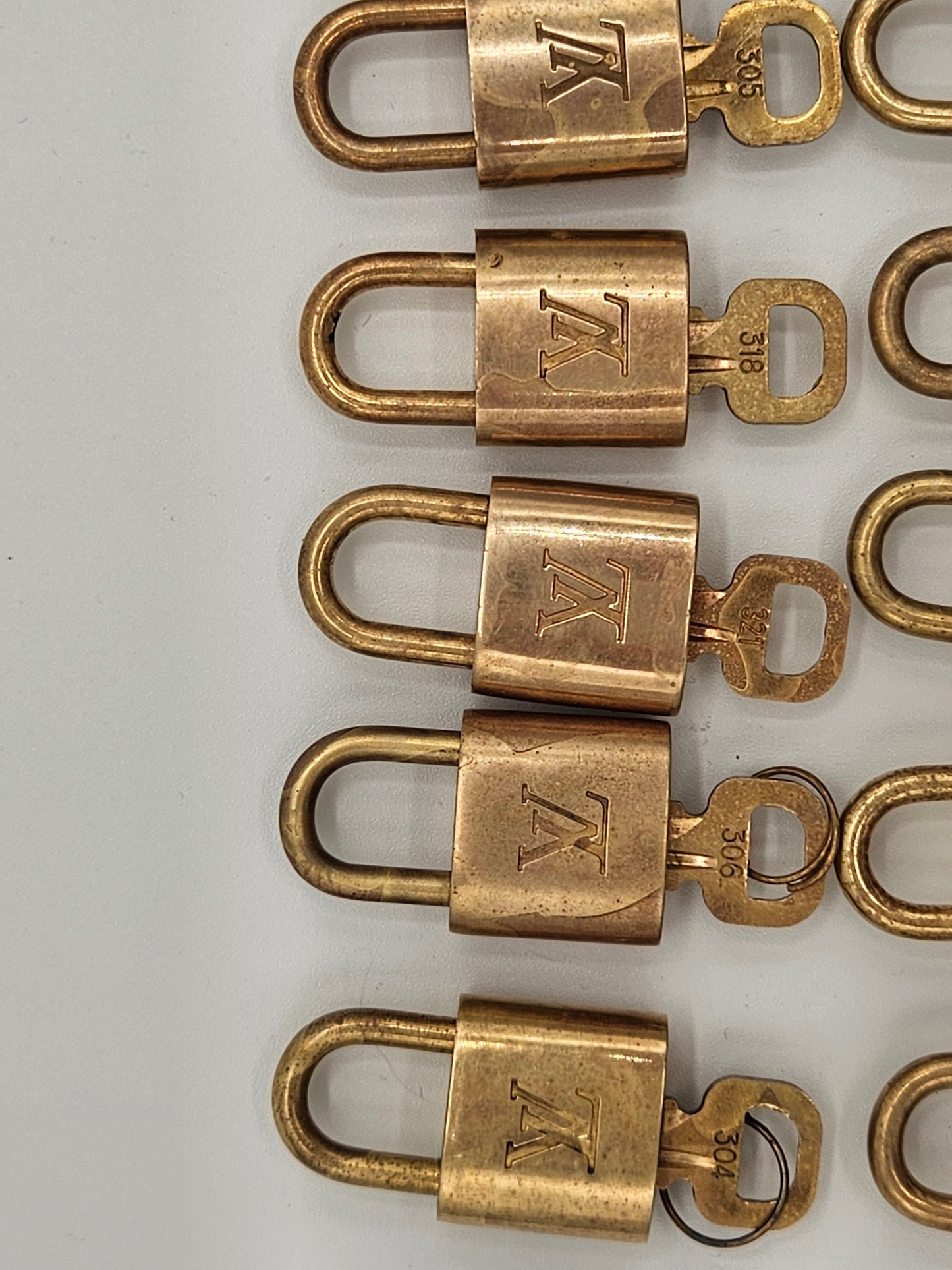 Row of brass locks with a visible brand logo on a white background