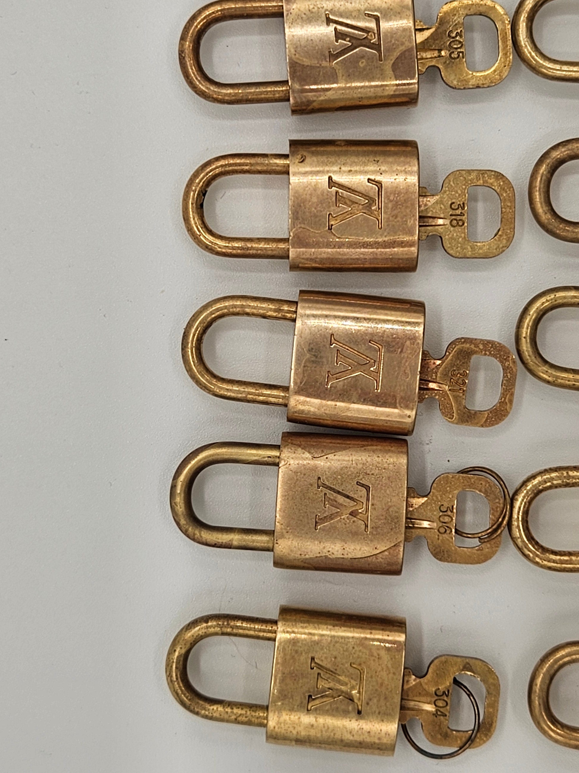 Row of brass locks with a visible brand logo on a white background