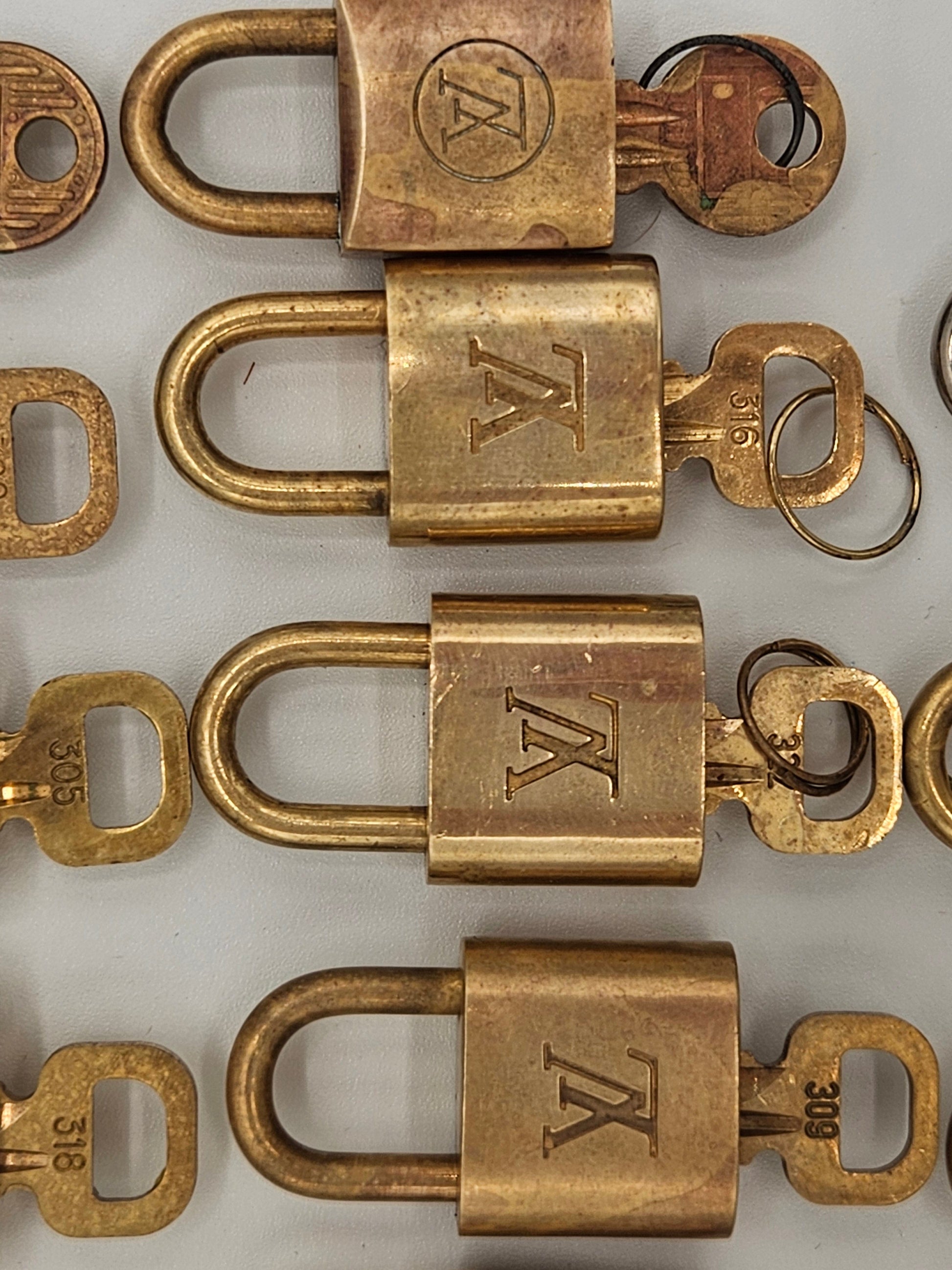 Collection of brass locks with 'TK' logo on a white background