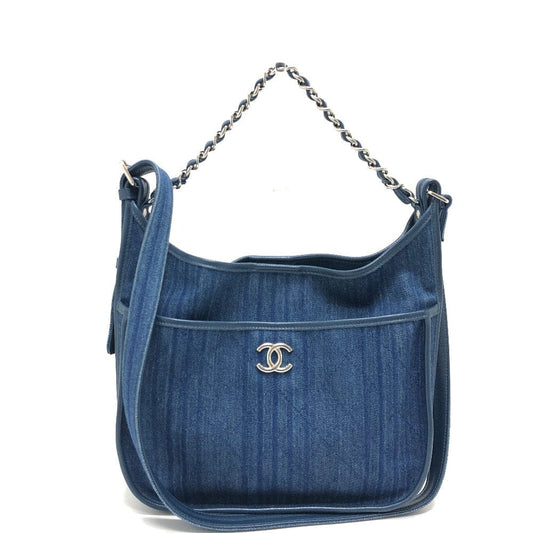 Blue denim handbag with a chain strap on a white background