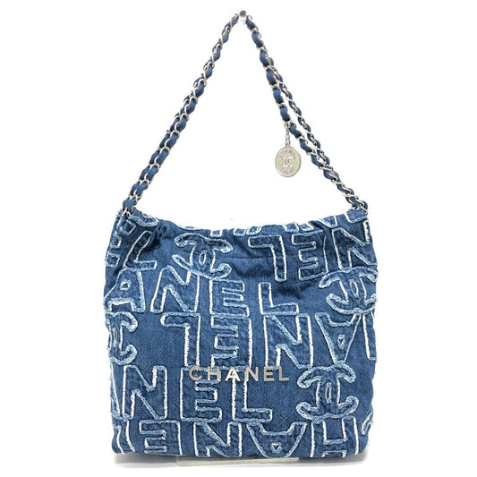 Blue denim handbag with white text and Chanel logo on a white background