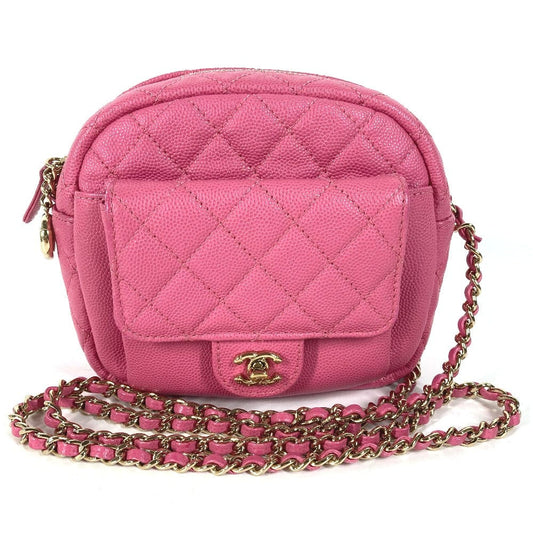 Pink quilted handbag with gold chain on a white background