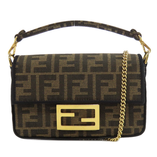 Designer handbag with gold chain and logo on a white background