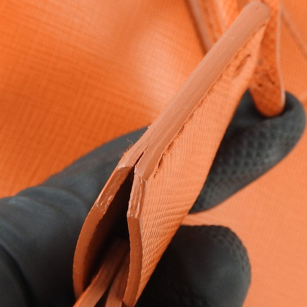 Close-up of an orange textured surface with a brown handle.