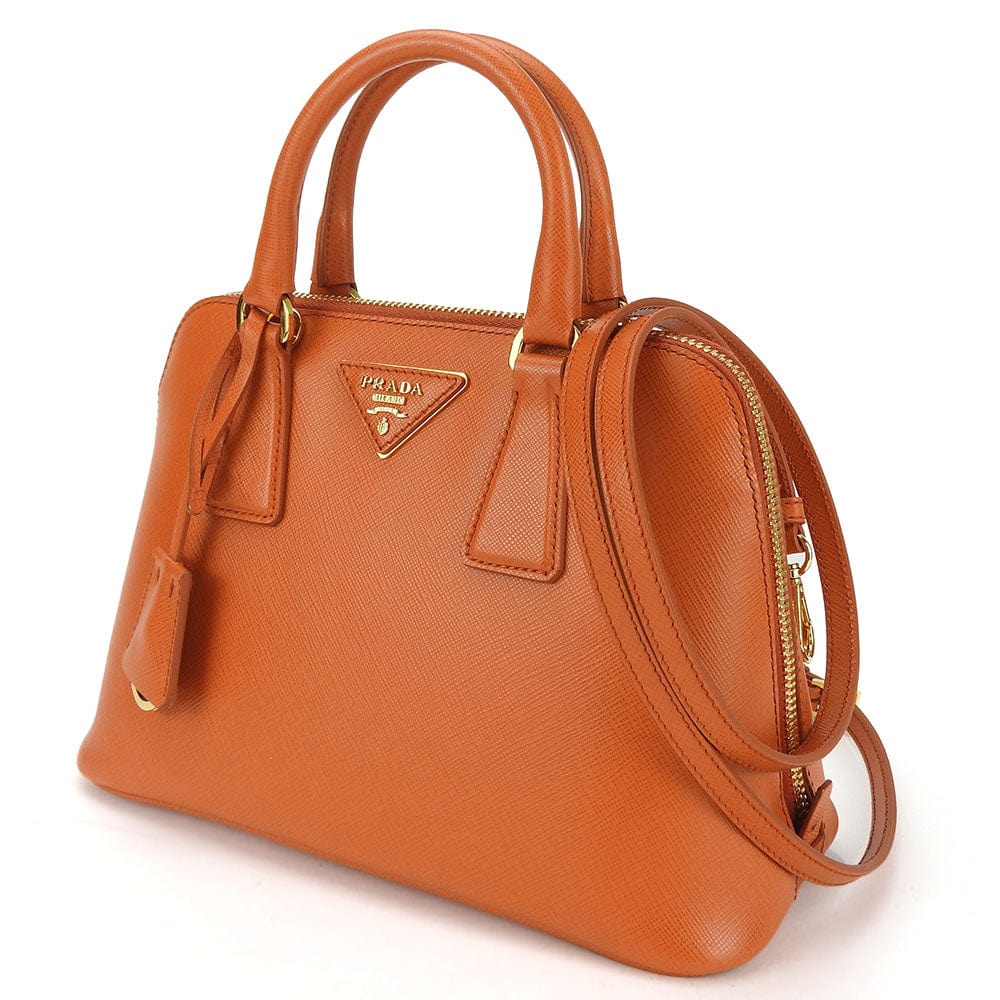Brown Prada handbag on a white background