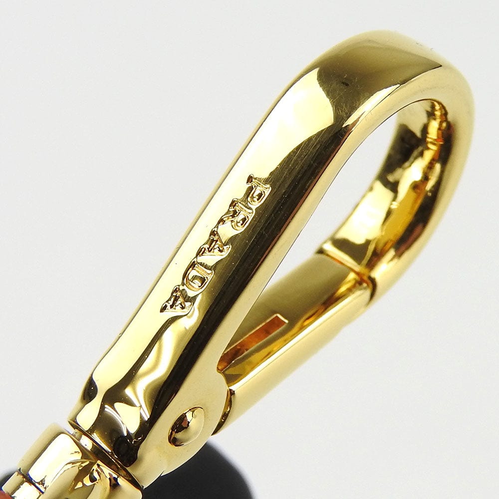 Gold ring with a brand logo on a light gray background