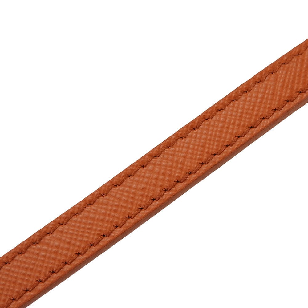 Close-up of a brown textured belt strap on a white background