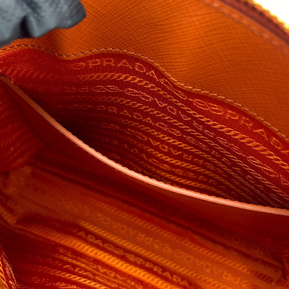 Close-up of Prada handbag with visible branding and texture.