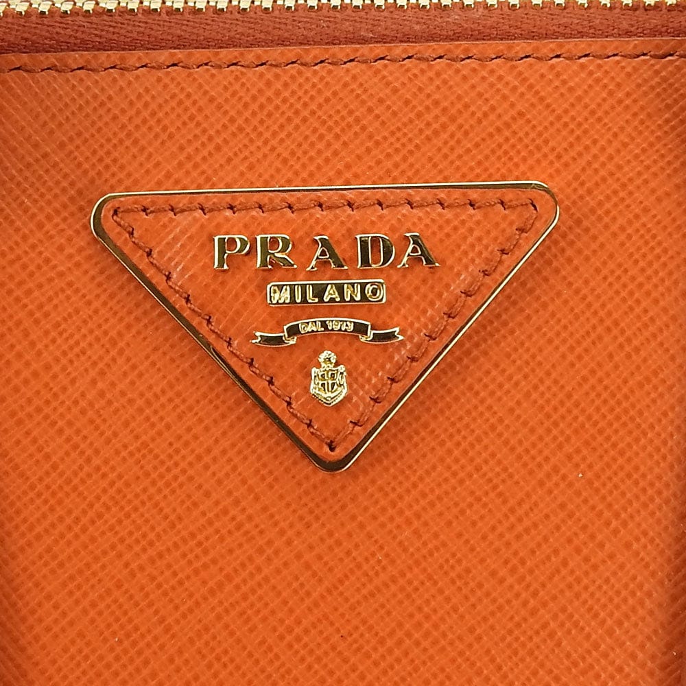 Close-up of Prada logo on an orange leather product
