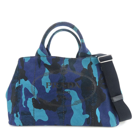 Blue camouflage handbag with Prada logo on a white background