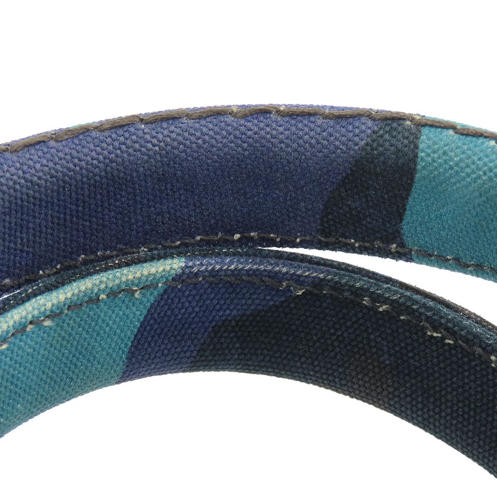 Close-up of a blue and green fabric belt on a white background