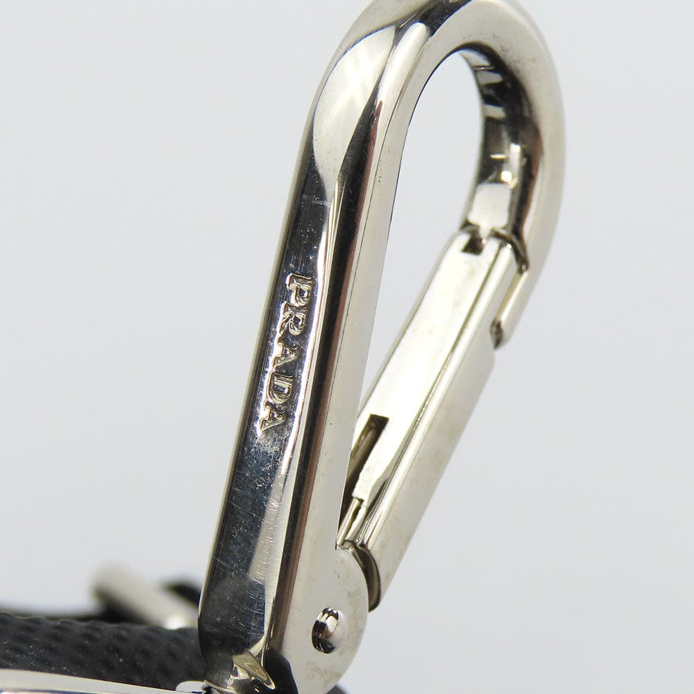 Close-up of a Prada metal carabiner on a white background