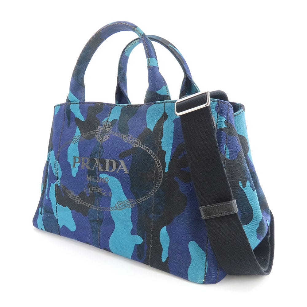 Blue camouflage Prada handbag with a shoulder strap on a white background