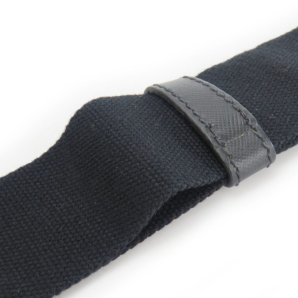 Close-up of a black belt with a gray buckle on a white background