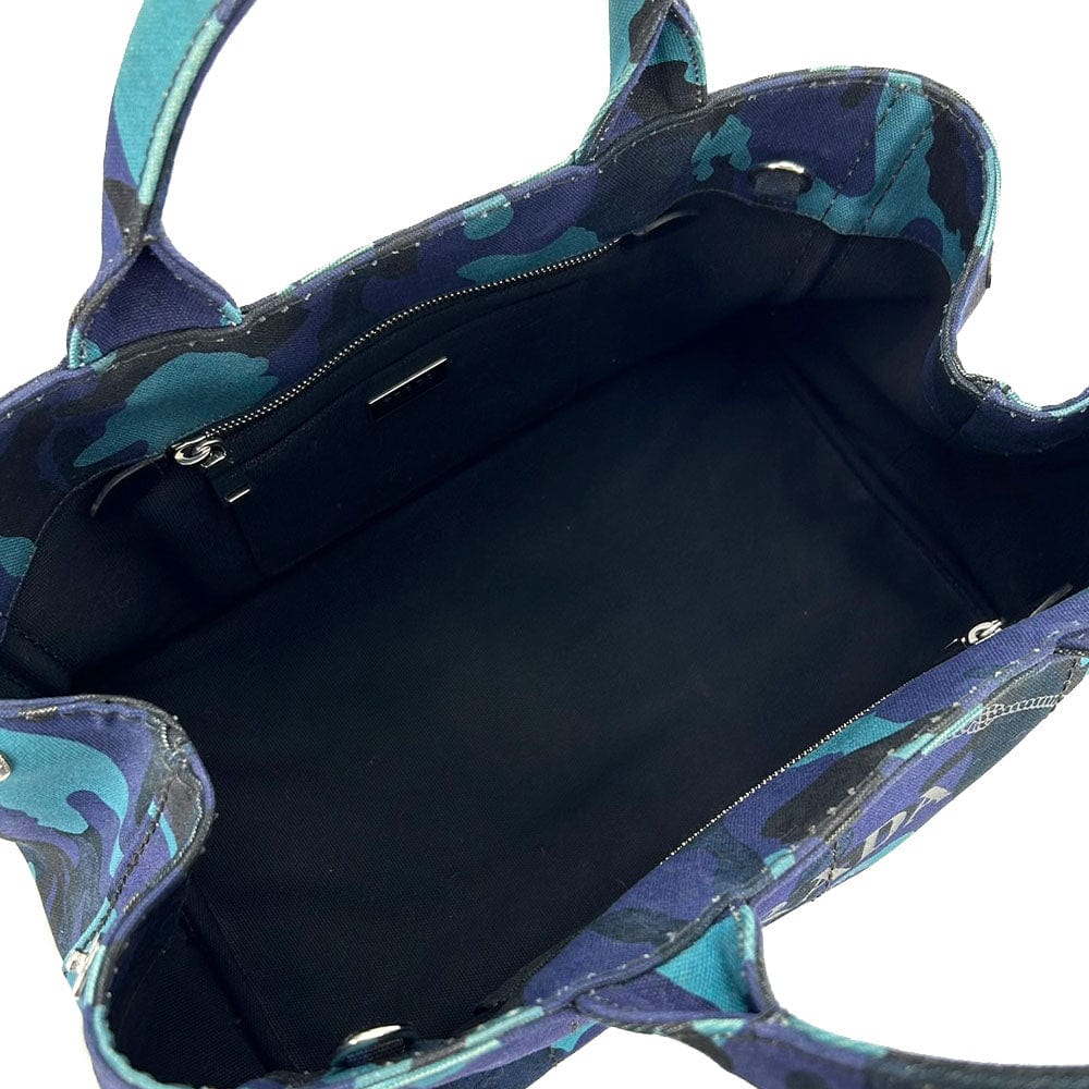 Blue and green patterned handbag with open front showing black interior.