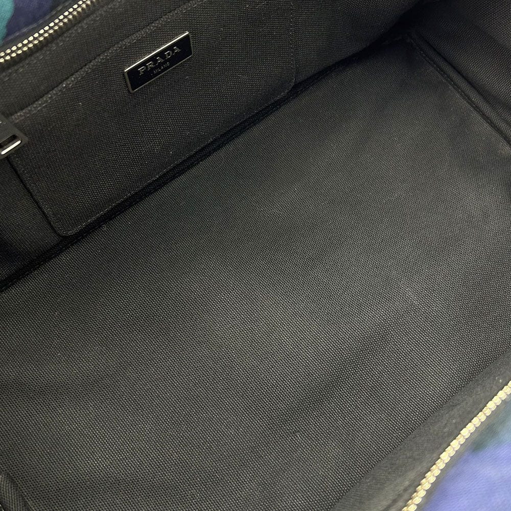 Black Prada bag with visible logo on a textured surface