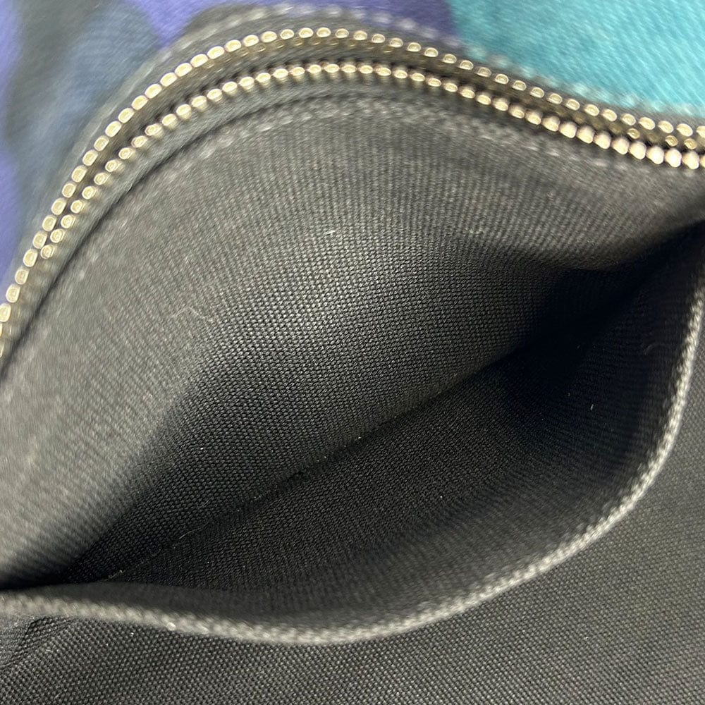 Close-up of a gray fabric interior with a zipper, showing texture and stitching details.