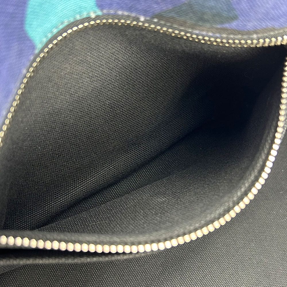 Close-up of a black fabric interior with a zipper, showing texture and color contrast.