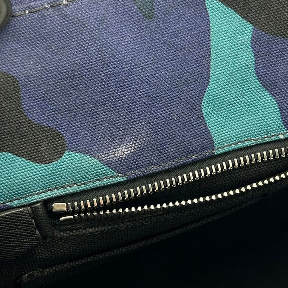 Close-up of a camouflage-patterned bag with a zipper