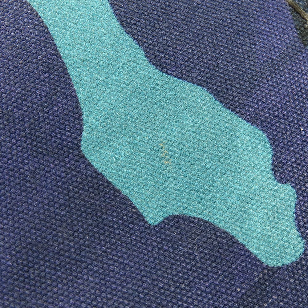 Close-up of blue fabric with a green patch