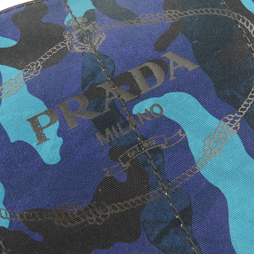 Close-up of Prada fabric with blue, black, and turquoise camouflage pattern.