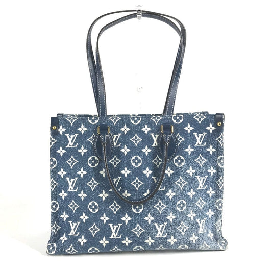 Blue tote bag with white monogram pattern on a white background