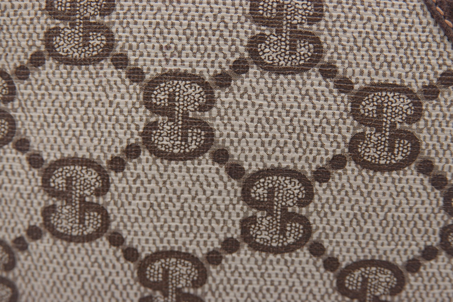 Close-up of a fabric with a brown and black pattern on a gray background