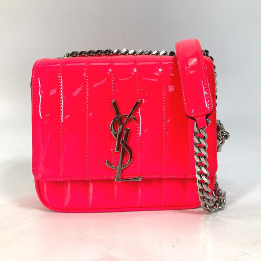 Pink handbag with a chain strap on a light gray background
