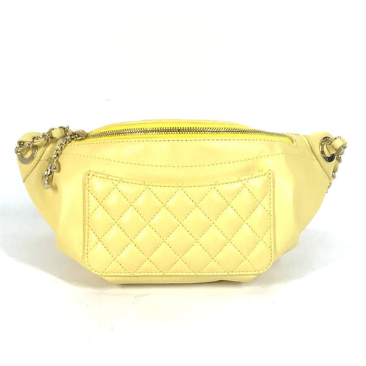 Yellow quilted fanny pack on a white background