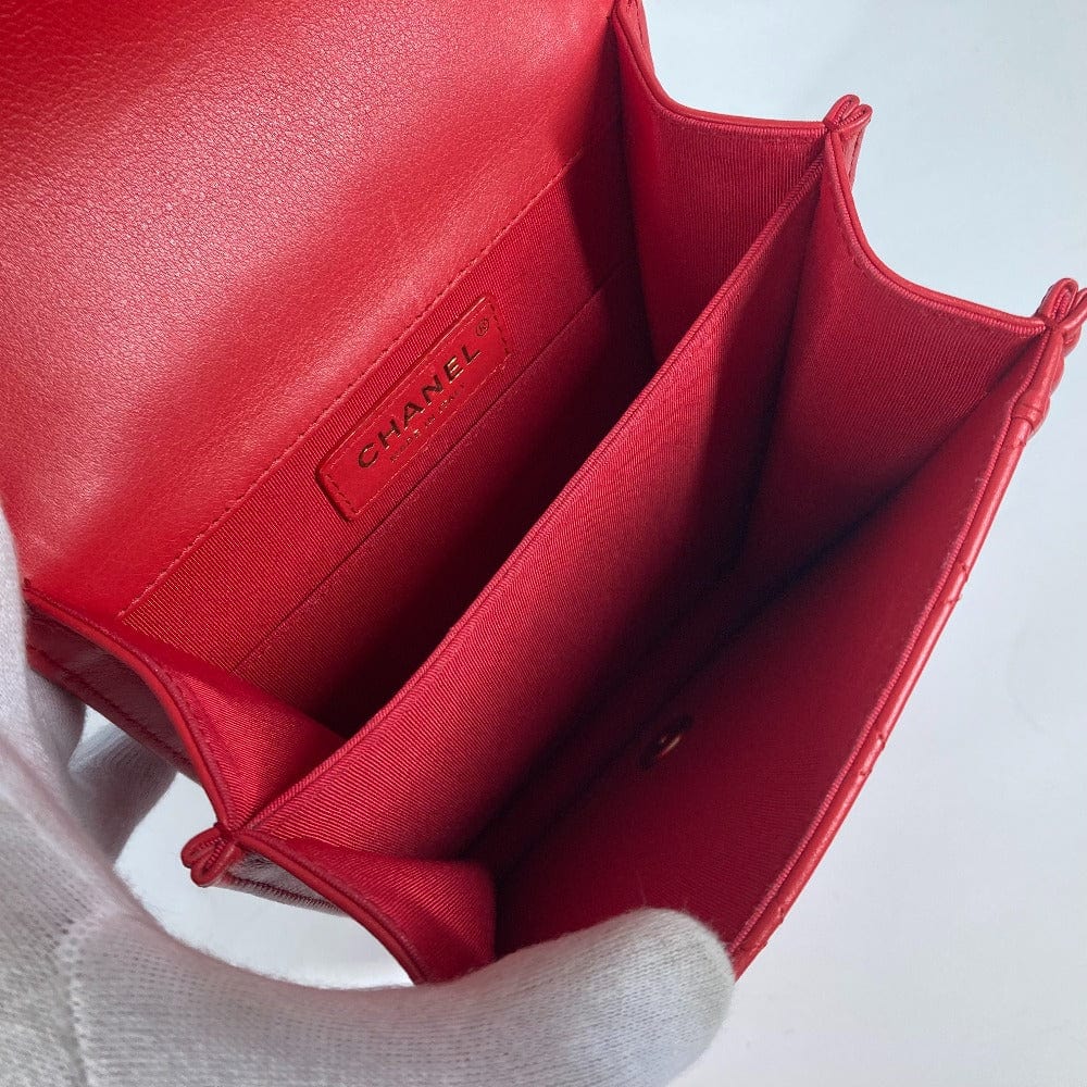 Red Chanel handbag on a light gray background