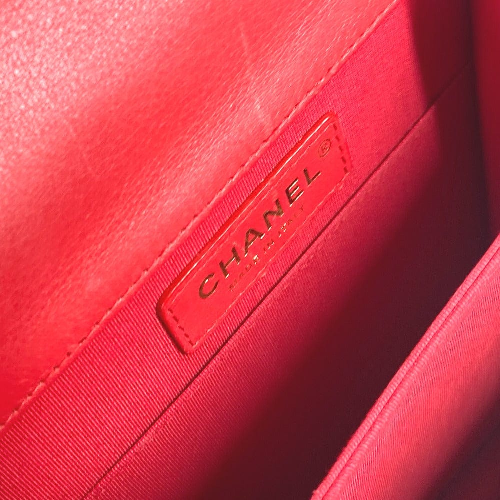 Close-up of a red Chanel handbag with the brand logo.