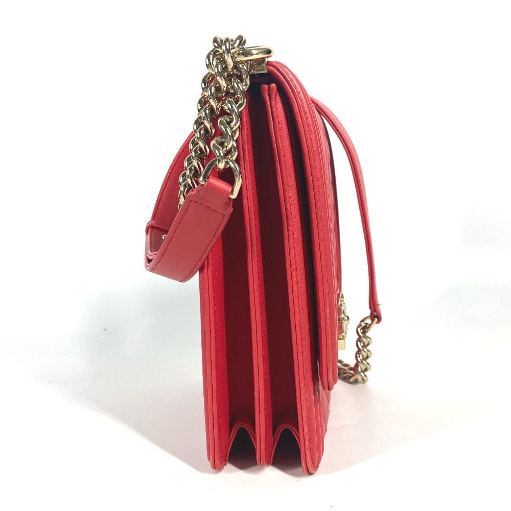 Red handbag with gold chain strap on a white background