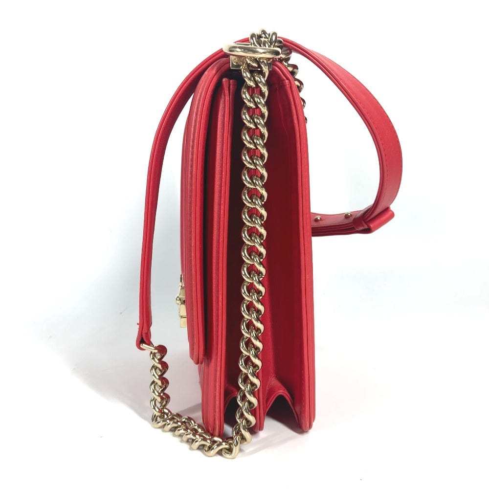 Red handbag with a gold chain strap on a white background