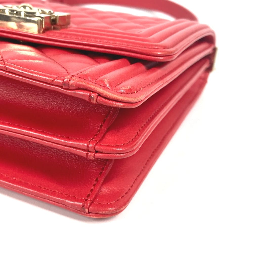 Close-up of a red handbag with a gold clasp on a white background