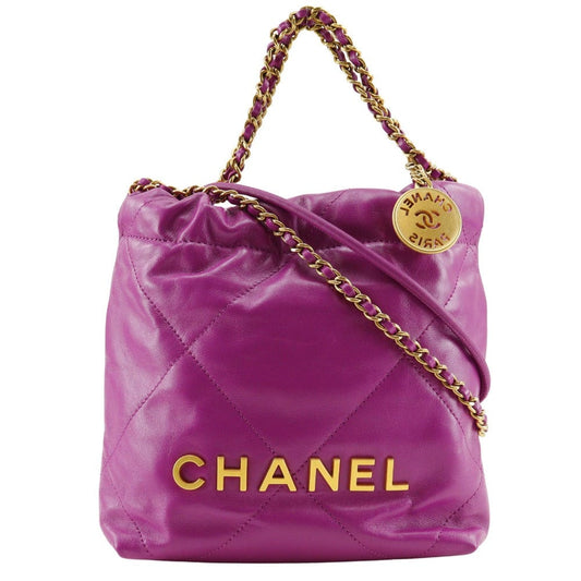 Purple Chanel handbag with gold chain and logo on a white background