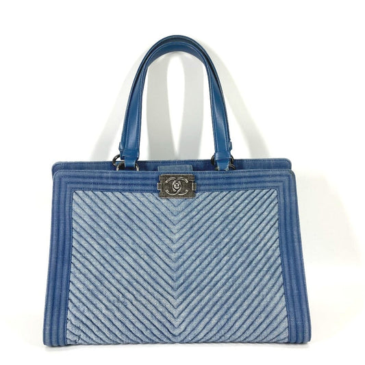 Blue handbag with a chevron pattern on a white background