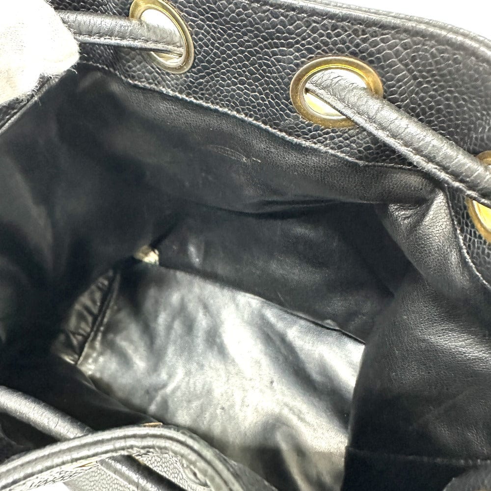 Close-up of a black leather handbag with gold hardware.