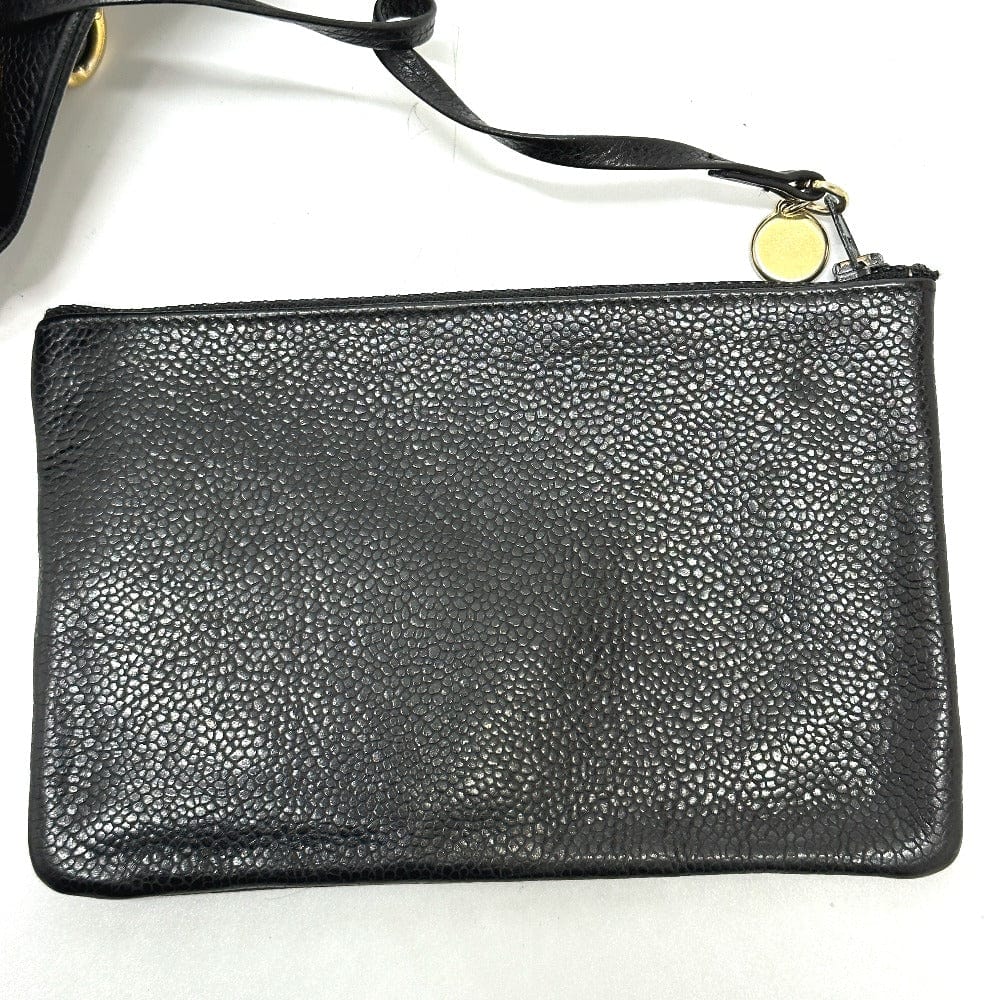 Black leather clutch bag with gold zipper on a white background