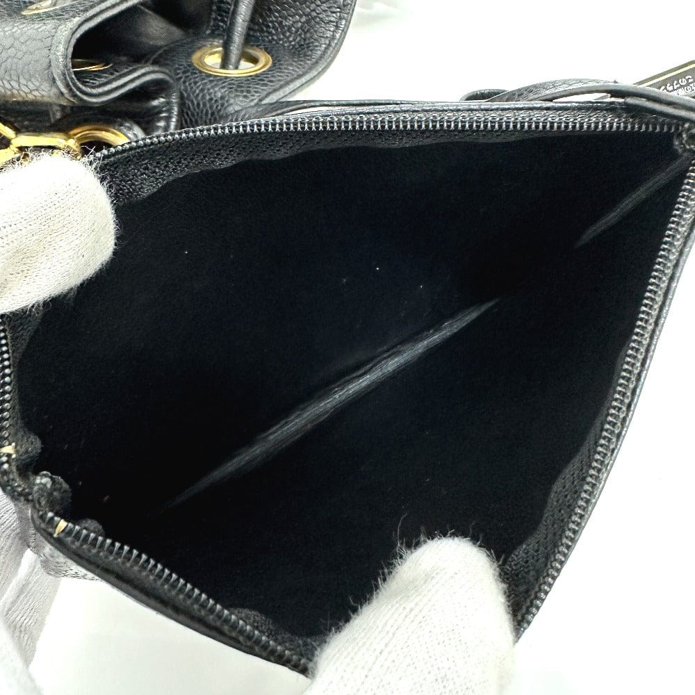 Black handbag with open zipper showing black interior