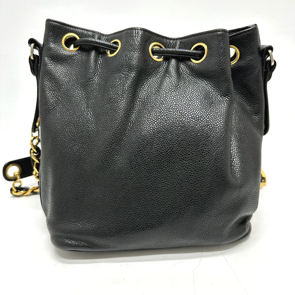 Black leather handbag with gold chain and hardware on a white background