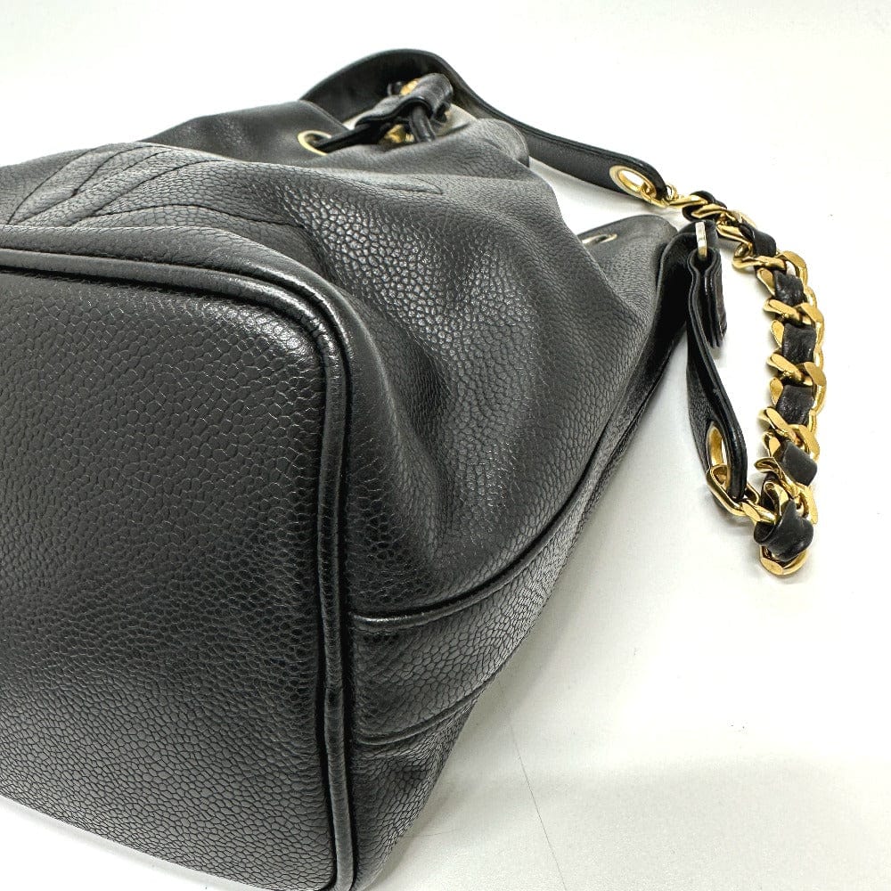 Black leather handbag with a gold chain strap on a white background