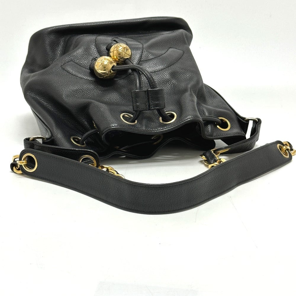 Black leather bag with gold accents on a white background